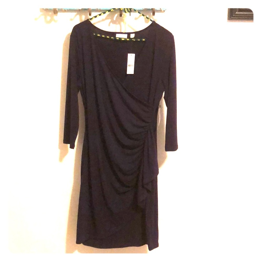 Dark purple, falls to the knee, dress.